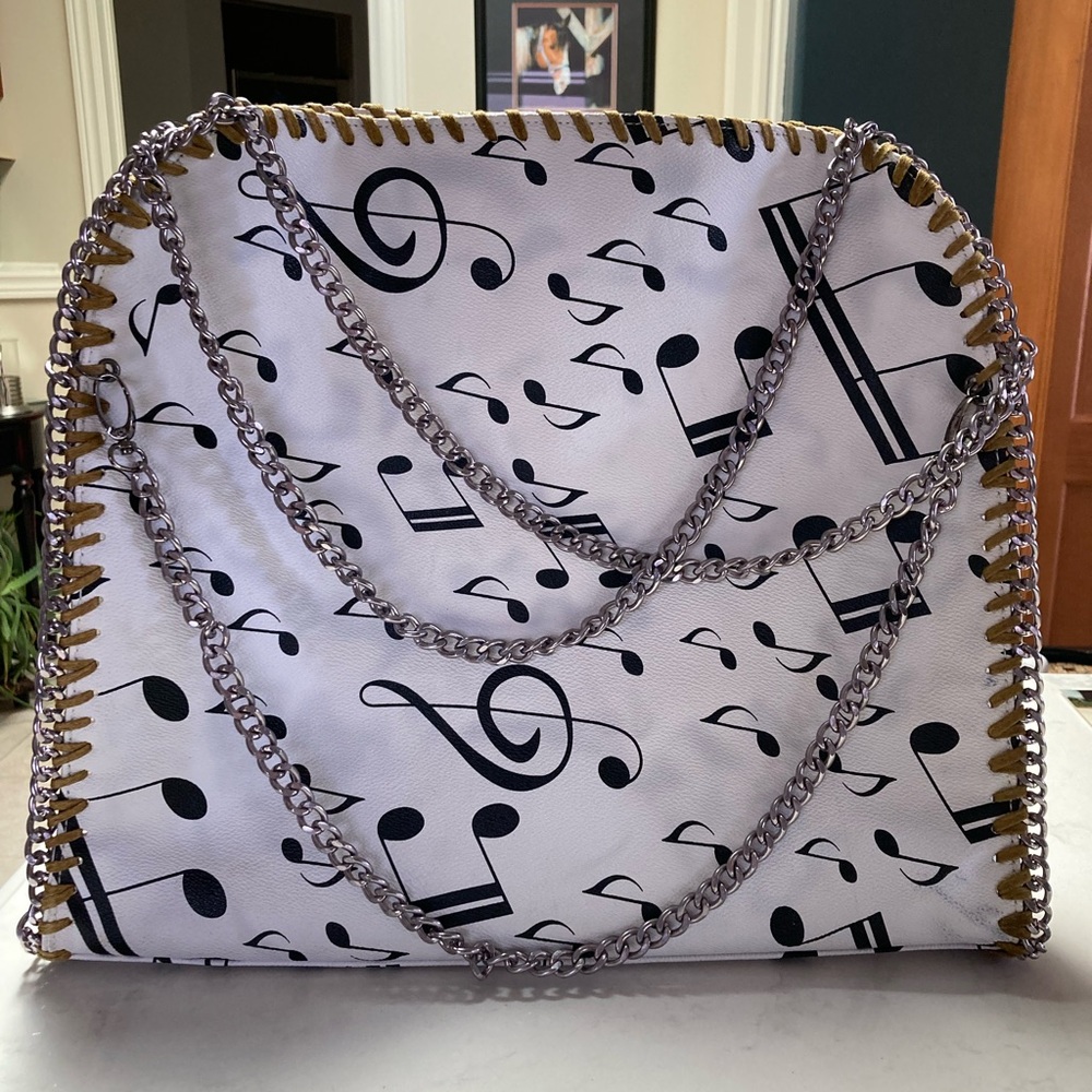 Musical notes & Chains. White vegan leather tote. 5 interior pockets Dual straps